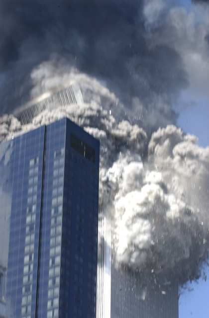 Figure 27. (9/11/2001) WTC2 top block completely vanished into dust cloud mid-air, demonstrating rapid macroscopic aerosolization before ground impact
  <br>
  - Photo by Amy Sancetta/AP